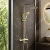 A modern bathroom with a gold shower set. Anteprima dell’immagine prodotto