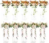 A set of ten clear acrylic flower stands with floral arrangements. Voir les images du produit