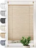 A window with beige pleated blinds and a small green plant in a pot in front of it. Swatches of different colored blinds are shown on the left side of the image. Produktbild-Vorschau