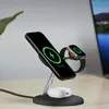 A black wireless charging stand with a phone and smartwatch charging. Produktbild-Vorschau