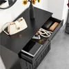 A black entryway cabinet with a drawer pulled out, showing various accessories inside. Produktbild-Vorschau