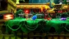 A vibrant, cartoonish video game environment with a blue character in the foreground. Podgląd zdjęcia produktu