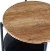 A close-up view of a round side table with a wood-grain top and a black storage basket underneath. Náhled obrázku produktu