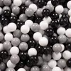 A pile of round balls in various shades of gray, white, and black. Anteprima dell’immagine prodotto