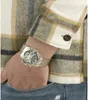 A close-up shot of a person's wrist wearing a silver watch, with a plaid shirt and denim jeans visible. Náhled obrázku produktu