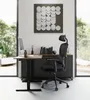 A modern office setup with an ergonomic chair and desk in a well-lit room with large windows. Produktbild-Vorschau