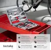A bicycle tool kit is displayed on a red tool cart, with a bicycle in the background. Produktbild-Vorschau