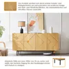 A wooden sideboard with a modern design, featuring decorative geometric patterns and black metal legs, displayed in a well-lit room with a lamp and artwork. Náhľad obrázku produktu