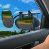 A view from inside a car looking out at a race track with auxiliary mirrors attached to the side mirror. Náhľad obrázku produktu