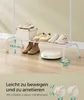 A white rolling garment rack with shoes and a storage box on its shelves, and a robot vacuum cleaner on the floor below. The image also includes text and graphics related to the product's features. Produktbild-Vorschau