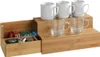 A bamboo tiered organizer for coffee and tea supplies, with mugs and glasses on top. Náhled obrázku produktu