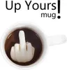 A white mug filled with dark liquid, with a ceramic middle finger figurine rising from the liquid. Produktbild-Vorschau