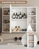 A white bathroom cabinet with its doors open, displaying various toiletries and bottles on shelves, mounted above a sink with black faucets. Voir les images du produit