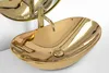 A close-up shot of a golden oval basin sink with a golden faucet. Náhled obrázku produktu