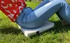 A person sitting on a cushion on the grass. Náhled obrázku produktu