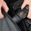 Hands placing a black pill organizer into a black bag. Podgląd zdjęcia produktu