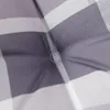 A close-up view of a gray and white checkered cushion. Produktbild-Vorschau