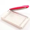 A paper trimmer with a pink handle and a white base, shown against a white background. Anteprima dell’immagine prodotto