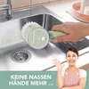 A person is cleaning a sink with an electric cleaning brush. Produktbild-Vorschau