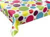 A close-up, angled view of a tablecloth with a colorful polka dot pattern, draped over a table corner. Náhľad obrázku produktu