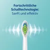Close-up of a sonic toothbrush head with radiating sound waves and text describing its technology. Produktbild-Vorschau