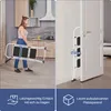 A woman is holding a folded stepladder in a kitchen, and the stepladder is shown stored in a narrow space next to a door. Produktbild-Vorschau