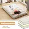 A woman is lying on a floor mattress in a bright, modern room. Náhľad obrázku produktu