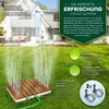 A wooden-topped garden sprinkler spraying water on a lawn, with a house in the background. Náhled obrázku produktu