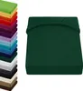 A stack of colorful fitted sheets is shown on the left, and a single dark green fitted sheet is displayed on the right. Produktbild-Vorschau