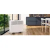 A portable air conditioner is shown in a modern kitchen setting next to a large window with greenery outside. Produktbild-Vorschau