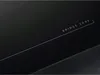 A close-up view of a black induction cooktop with the text 'BRIDGE ZONE' printed on it. Podgląd zdjęcia produktu