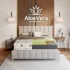 A cutaway view of a mattress on a bed in a bedroom setting. Produktbild-Vorschau