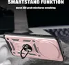 A rose gold phone case with a ring holder is shown in a close-up shot, with a blurred background of a laptop and headphones. Produktbild-Vorschau