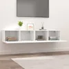 A white wall-mounted TV cabinet with four open compartments, displaying books and decorative items. Náhľad obrázku produktu