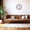 A living room scene with a brown sofa, a plant, and a clock on the wall. Voir les images du produit