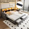 A modern grey upholstered daybed with a pull-out trundle bed and integrated shelving unit with LED lighting. The image also features a close-up inset of a power outlet with USB and Type-C charging ports. Náhled obrázku produktu