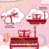 A red toy piano with microphones and musical notes, presented with illustrative clouds highlighting features. Podgląd zdjęcia produktu