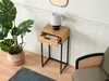 A narrow console table with a drawer, a lamp, and a plant in a basket, next to a chair. Produktbild-Vorschau