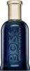 A studio shot of a dark blue perfume bottle with a gold cap. Náhled obrázku produktu