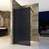 A modern bathroom with a black glass shower enclosure, marble-like tiles, and a view of a nighttime cityscape. Produktbild-Vorschau
