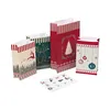 A collection of Christmas-themed paper bags and stickers arranged on a white background. Produktbild-Vorschau