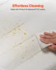 A hand is wiping a white surface with a wet wipe, demonstrating effortless cleaning. Podgląd zdjęcia produktu