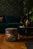 A living room scene with a sofa, coffee table, and a floral ottoman. Produktbild-Vorschau