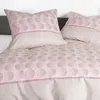 A close-up view of a bedding set with a patterned design. Produktbild-Vorschau