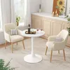 A small round white table with two beige chairs, set up in a cozy corner with a window and a cabinet in the background. Anteprima dell’immagine prodotto