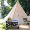 A camping scene with a large tent, a wagon filled with camping gear, and chairs. Produktbild-Vorschau