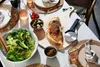 A table setting with a calzone, salad, olives, and drinks. Anteprima dell’immagine prodotto