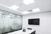 A modern conference room with a large screen on the wall and a glass partition. Náhľad obrázku produktu