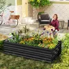 A woman is gardening next to a raised garden bed filled with flowers and plants. A bicycle is parked in the background. Náhled obrázku produktu