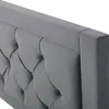 A close-up view of a gray upholstered headboard with button tufting. Podgląd zdjęcia produktu
